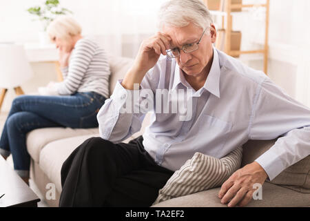 Relationship Problems. Senior Couple After Argument On Sofa Stock Photo