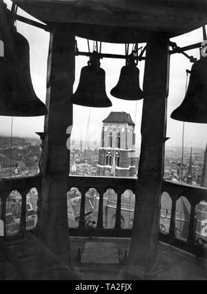 This photograph shows the carillon of the town hall tower in Gdansk, which was built in the 16th century. The Town Hall of Gdansk was built between 1379 and 1492. During the Second World War, the building burned down completely and was renovated subsequently. Today it houses the Historical Museum. Famous is the Red Hall, which was designed by architects Hans Vredemann de Vries, Izaak van de Blocke and Simon Herle. In the background is the Church of St. Mary. Stock Photo