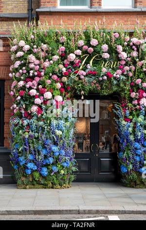 J Crew clothing shop floral display in Sloane Square for Chelsea in Bloom 2019. Chelsea, London, England Stock Photo