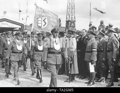 The marching Stahlhelm members are greeted among others by retired Generalfeldmarschall August von Mackensen (in light coat and with saber). One of the marching men carries a banner with the words 'Victory is based on Victims and on Weapons'. Stock Photo