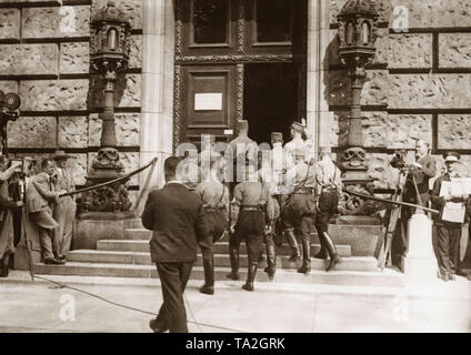 During the Reichstag elections the NSDAP received a substantial number of votes and became the strongest force in the German parliament. Here deputies enter the Reichstag building in their SA uniforms. Stock Photo