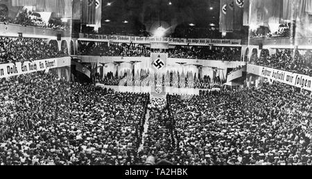 At the height of the Sudetenland crisis, Adolf Hitler gives a speech at the Berlin Sportpalast. He mentioned the cession of the Sudetenland to the German Reich as his last demand for territorial revision. On the posters on the side: 'One People, One Reich, One Fuehrer' and 'Fuehrer, give Your command and we follow'. Above the stage: 'The Germans in Czechoslovakia are neither defenseless nor abandoned. That should be acknowledged. ' Stock Photo