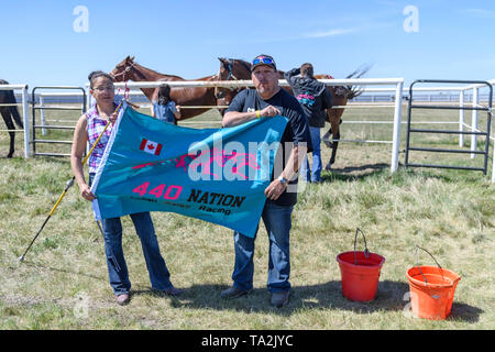 Canadian Indian Relay (horse) Race, Team 440 Nation flag displayed by two race captains/owners at the Rodeo Grounds in Bonnyville Alberta Canada Stock Photo