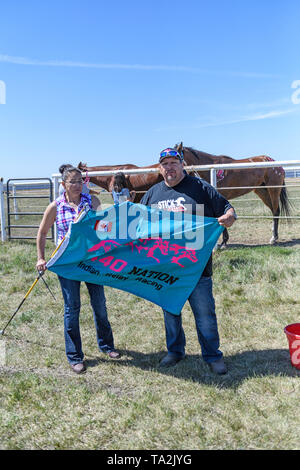 Canadian Indian Relay (horse) Race, Team 440 Nation flag displayed by two race captains/owners at the Rodeo Grounds in Bonnyville Alberta Canada Stock Photo