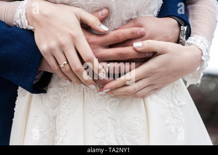 Hands of bride and groom with rings close up. Wedding and family concept. Stock Photo