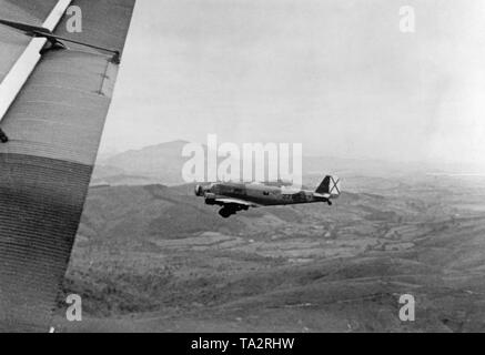 The photo shows a German Junkers Ju 52 transport aircraft with the paintwork of the German Condor Legion loaded with Moroccan soldiers on the flight from Tetouan, Spanish-Morocco, Africat to the Spanish mainland in the summer of 1936. After the outbreak of the Spanish Civil War on July 27, 1936, Germany provided military assistance to General Franco (Operation Feuerzeauber). In addition, 20 Ju-52s (mostly Lufthansa aircrafts) were provided, which flew more than 800 flights of Spanish national troops, including 14,000 Moroccan foreign legionaries (Fuerzas Regulares Indigenas), and materials Stock Photo