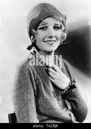 Portrait of American actress Anita Page with a cloche hat. She wears jewelry made of buttons. Stock Photo