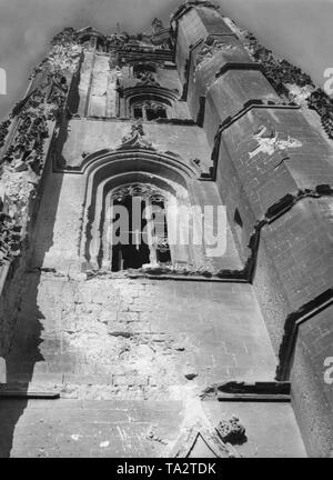 Undated photo of a destroyed church. Low angle shot onto a church facade of an unknown church, which was partly destroyed by heavy weapons, presumably artillery grenades. Bullet shots are also discernible. Stock Photo
