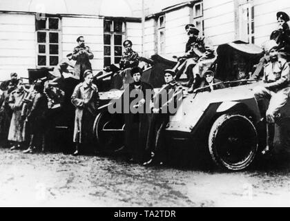 Armored cars and their crews parked for the personal protection of Lenin in the courtyard of the Smolny Institute, the seat of the Petrograd Soviet. Stock Photo