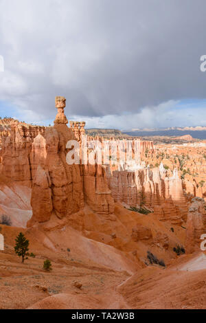 Storm clouds over a sandstone hoodoo rock pillar in Long Canyon, Behind ...