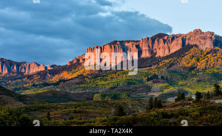 Sunset at Cimarron Ridge - Autumn sunset view of rugged Cimarron Ridge South, part of San Juan Mountains, seen from Owl Creek Pass Road. Ridgeway, CO. Stock Photo