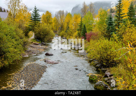 Misty Autumn Mountain Creek - Autumn view of San Miguel River, running through the town of Telluride, Colorado, USA. Stock Photo