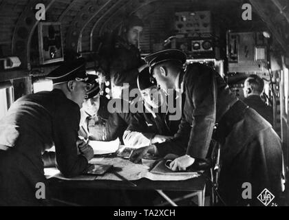 Film scene from the short 'documentary' called 'Flieger, Funker, Kanoniere' from 1937. The propagandistic short film begins with a preface of Hermann Goering and afterwards shows scenes of maneuvers of the Luftwaffe. This picture shows navigation lessons aboard an aircraft ('Hoersaalmaschine' - lecture hall engine). Stock Photo