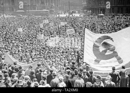 May Day celebrations in New York, where a demonstration with flags of hammer and sickle takes place. Stock Photo