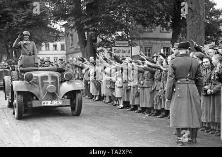 German troops cross the border near Czechoslovakia at Sohland an der Spree. According to the Munich Agreement, the Sudetenland is annexed to the German Reich. The bystanders greet the passing soldiers by giving them the Hitler salute. Stock Photo