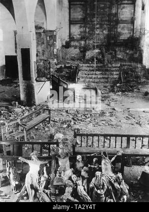 Photo of a destroyed and partially burned-out altar of an unknown church in Madrid, 1936. In the foreground, destroyed figures of saints and crucifixes. In the background, the completely burned-out altar of the church. In the center, debris and shattered bricks. Stock Photo