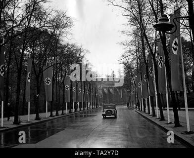 View through the Friedensallee (today: Simsonweg) in the Tiergarten. In the background, the Brandenburg Gate. The car belongs to the Luftwaffe. Due to a speech of Adolf Hitler in the Kroll Opera House to terminate the German-Polish non-aggression pact and the German-British naval agreement, the street is empty. Stock Photo