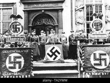 Chief of Staff of the SA Wilhelm Schepmann swears in new Volkssturm men of the Nazi Gau Gdansk-West Prussia  in front of the Artus Court in Gdansk. Volkssturm denotes the German military formation, which was used by the National Socialists to support the Wehrmacht in the final phase of Second World War. On the swastika flags: 'Germany wake up'. Stock Photo