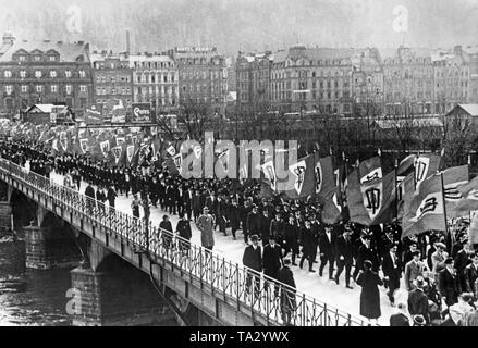 Flag bearers of the Sudeten German Party cross the Egerbruecke (bridge in Cheb) in Karlsbad (today Karlovy Vary). There is a meeting of the Sudeten German Party in Karlsbad, at which Karl Hermann Frank gives a speech. Stock Photo