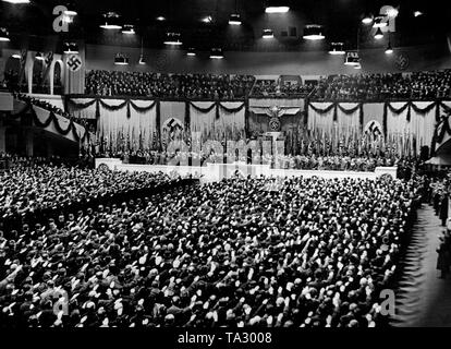 After Minister of Propaganda Joseph Goebbels has read Adolf Hitler's proclamation on the 10th anniversary of the seizure of power, the attendees rise. Finally, ideological songs of the party are sung. Propaganda photo. Stock Photo