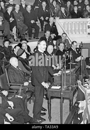 British Prime Minister Neville Chamberlain gives a speech at the meeting of the Birmingham Unionist Association about the occupation of Czechoslovakia by Hitler. He announces that Britain will not surrender. On Hitler's command, the first Slovak Republic was founded in March 1939, and German troops marched into the remaining areas of Bohemia and Moravia. Stock Photo