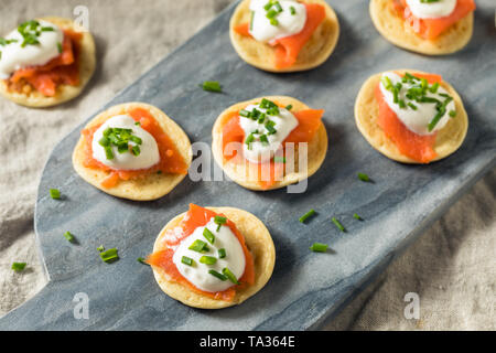 Homemade Smoked Salmon Cocktail Blinis with Creme and Chives Stock Photo