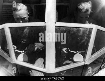 Two student pilots receive instruction at the yoke of an aircraft. Stock Photo