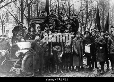 Soldiers of the newly formed Red Army pose for a photo in front of the Smolny Institute, the seat of the Petrograd Soviet. Stock Photo