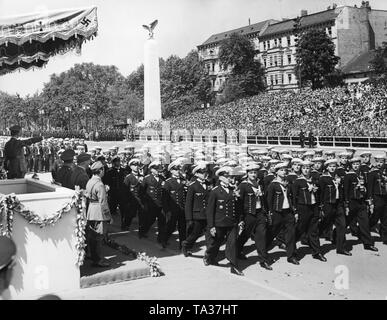 Photo of a marine formation (sailors and corporals) marching in front of officers of the Wehrmacht and leader, Adolf Hitler (under a canopy), at the parade of the Condor Legion on the East-West Axis (former Chalottenburger Chaussee, today Strasse des 17. Juni ) in front of the Technische Universitaet on June 6, 1939. Stock Photo