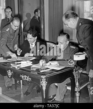 Matus Cernak (2nd from left) and Joachim von Ribbentrop (2nd from right) sign the German-Slovakian Treaty at the Federal Foreign Office in Berlin. To Cernak's left, Envoy Heinburg and to Rippentrop's right, Envoy Schmidt. The first Slovak Republic was founded on Hitler's command in March 1939, and Bohemia and Moravia were occupied by the Wehrmacht. Stock Photo