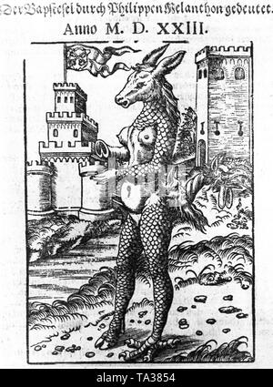 'Der Papstesel zu Rom' (The Papacy of Rome) is the title of a satirical leaflet, published in 1523 by Martin Luther and Philipp Melanchthon. Lucas Cranach the Elder made this painting. This caricature is hanging in the Lutherhalle in Wittenberg. In the focus is an upright donkey and in the background are two castles, on the left is a papal flag. Stock Photo