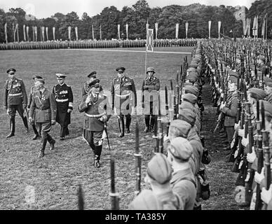 Photo of Field Marshal General Hermann Goering (in the front on the right) inspecting the troops of the legionaries with the commander of the Condor Legion, Major General Wolfram Freiherr von Richthofen (left) in the Moorweide, Hamburg. Behind, from left to right: General der Flieger Helmuth Volkmann, General of the Cavalry Wilhelm Knochenhauer, General Admiral Conrad Albrecht, Colonel-General Erhard Milch and General der Flieger Hugo Sperrle. Stock Photo