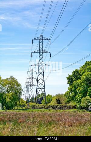 Electricity pylons marching across the countryside in Hertfordshire UK ...