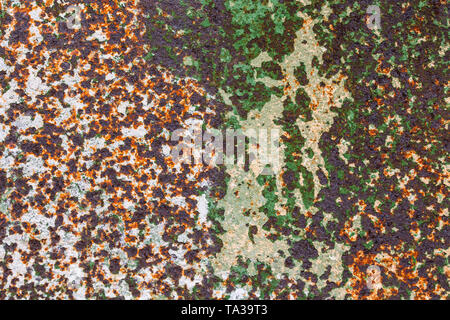 corroded peel paint metal surface background with spots of rust, white and green paint Stock Photo
