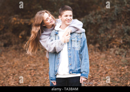 Happy love teen couple having fun outdoors. Wearing stylish denim clothes. Valentines day. Stock Photo
