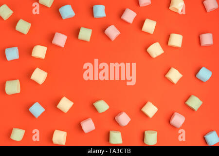 Living coral, color of the year 2019. Mini marshmallows on trendy pastel coral background. Flat lay, copy space Stock Photo