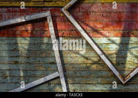 Abstract composition with a frames on old wooden wall with weathered peeling paint Stock Photo