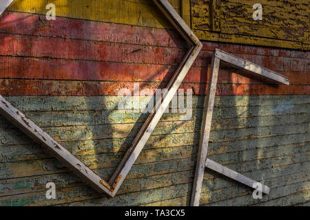 Abstract composition with a frames on old wooden wall with weathered peeling paint Stock Photo