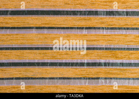 orange striped synthetic woven upholstery fabric close-up texture and background Stock Photo