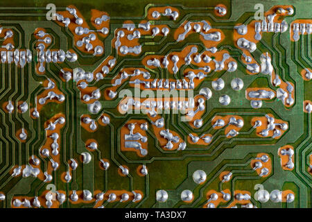 back side of two-layered green analog pcb without components background Stock Photo