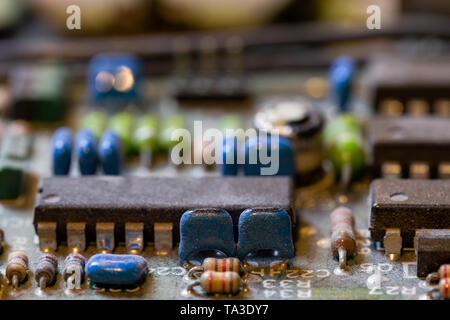 dark background of old electronic circuit board closeup with dus Stock Photo