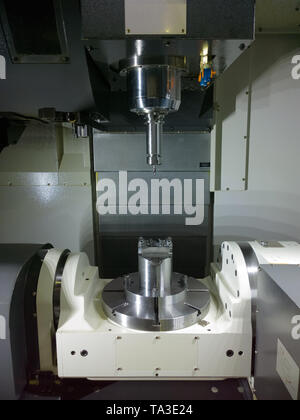 The five-axis Computer Numerical Control CNC machine waiting for stock change. Stock Photo