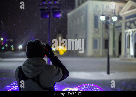 professional photographer shooting night architecture view handheld at snowy winter with natural light and selective focus Stock Photo