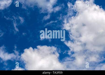 white c cumulus clouds on blue sky background telephoto view Stock Photo