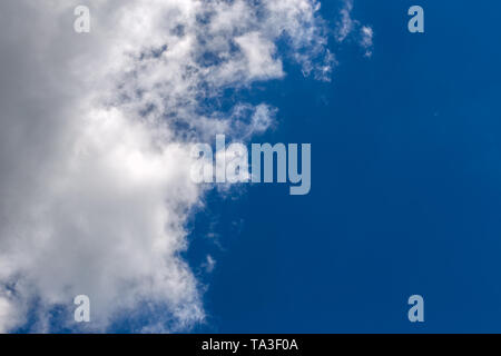 white c cumulus clouds on blue sky background telephoto view Stock Photo