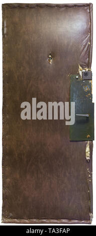Old russian cheap apartment door covered by leatherette, insulated with wadding and fixed with green painted plywood board. Stock Photo