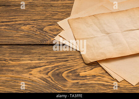 sheets of old paper on table Stock Photo