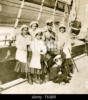 Tsar Nicholas II of Russia with his children on the imperial yacht. From left: Maria, Olga, Anastasia, the Tsar, his son and successor to the throne Alexei, Tatiana. Stock Photo