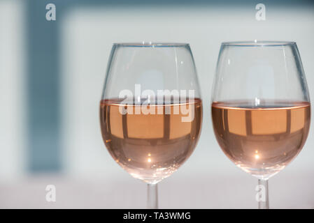 Two glasses of rose wine on a wooden table in sunlight Stock Photo