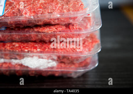 Packet of ground beef or minced beef from Fresh Choice supermarket. On plastic tray with plastic wrap or glad wrap, cling film. Bought on special. Stock Photo